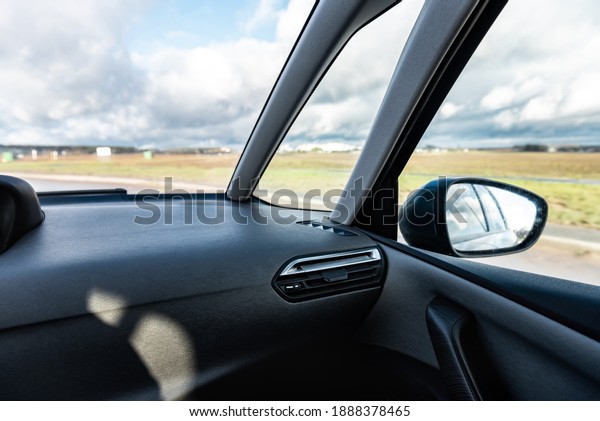 A man\
driving a car with a front view of the\
road.
