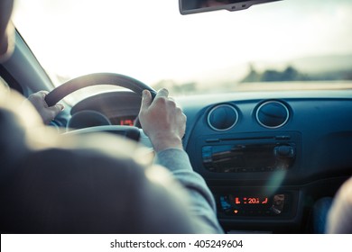 Man Driving Car, Hand On Steering Wheel, Looking At The Road Ahead.