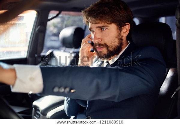 man driving a car looks in the front window             
            