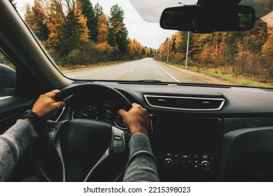 Man Driving Car On The Country Road In Autumn. Rear View