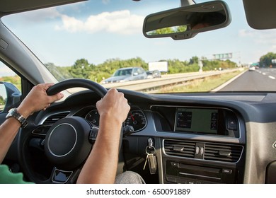 man driving a car. people traveling at the wheel