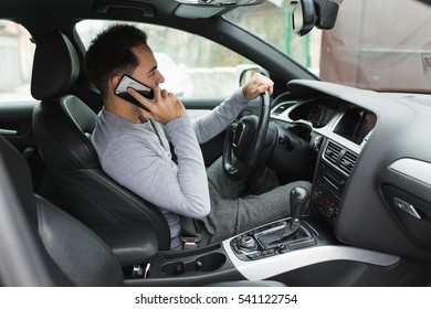 Man Driving Car And Phone