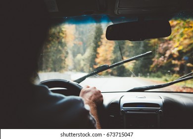 Man Driving Car In Rain Weather. Fall Trip. Wipers Cleaning Windshield. Freedom Travel Concept. Autumn Weekend.