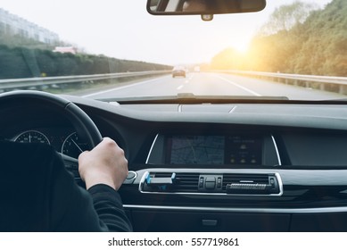man driving car from rear view on the highway. - Shutterstock ID 557719861