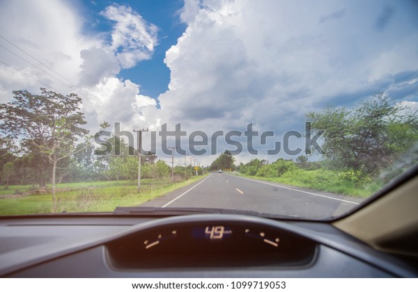 Man Driving\
car from rear view on the\
highway.