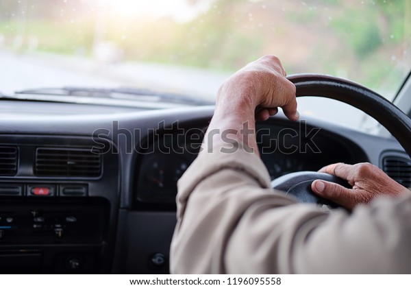 Man driving\
car from rear view on the\
highway.