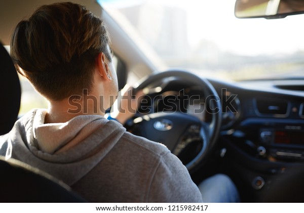 man driving car, rear view. Car driveng and\
travel concept