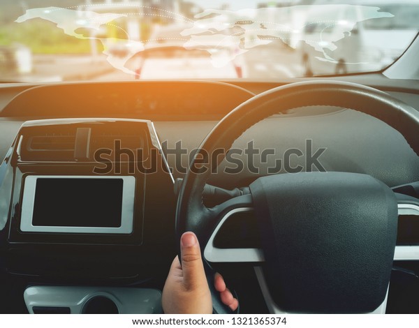 Man driving car from rear\
view on the highway. Driver\'s hands on the steering wheel inside of\
a car 
