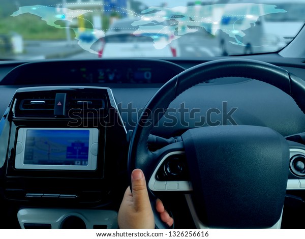 Man driving car from rear
view on the highway. Driver's hands on the steering wheel inside of
a car 