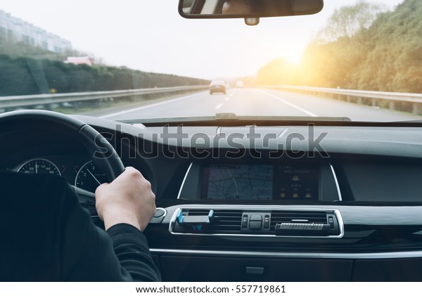 man driving\
car from rear view on the\
highway.