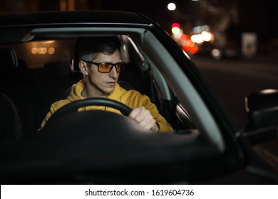 Man Driving Car In Special Yellow Eyeglasses At Night For Good Night Vision