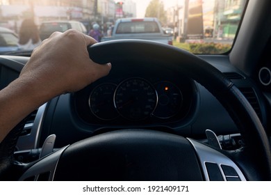 Man Driving Car Stop In Traffic Light, Single Hand On Steering Wheel, Go To Business Trip Or Travel In City.