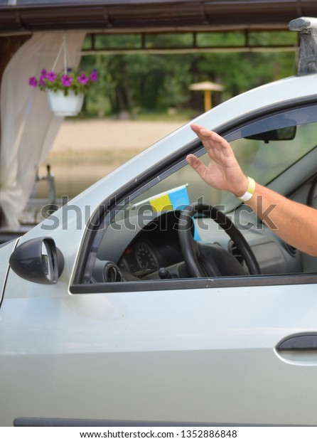 man driving a car in summer posing for a\
photographer in nature. man driving a car in summer posing for a\
photographer in nature