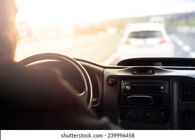 Man Driving A Car At Sunset