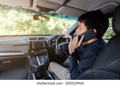 Man Driving A Car And Talking On A Mobile Phone