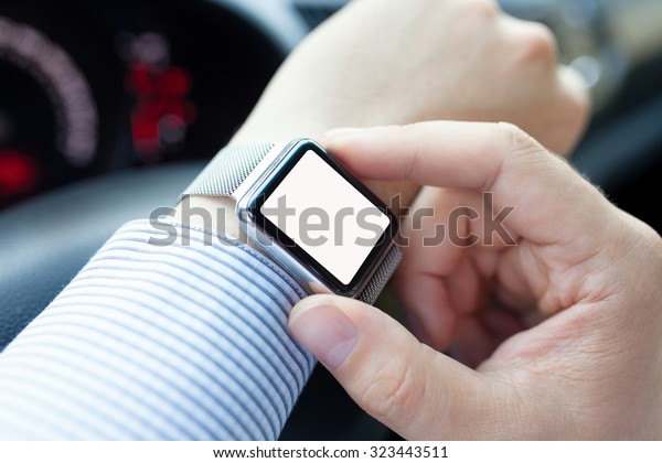man driving a car and watch with isolated screen on\
the hand