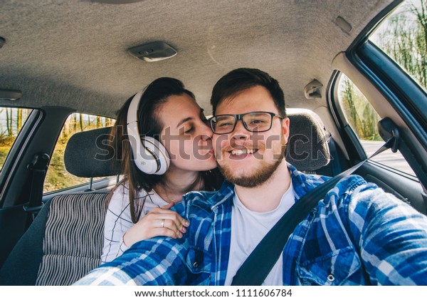 man driving car. woman sitting as passenger at\
backseats. car travel\
concept