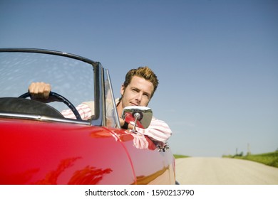 Man Driving Convertible In Countryside