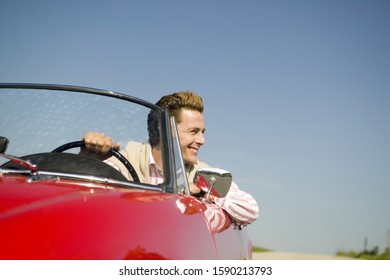 Man Driving Convertible In Countryside