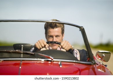 Man Driving Convertible In Countryside