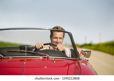 Man Driving Convertible In Countryside