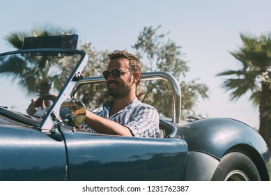 Man Driving A Convertible Vintage Car