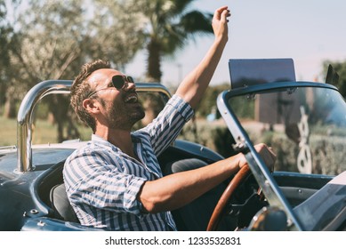 Man Driving A Convertible Vintage Car