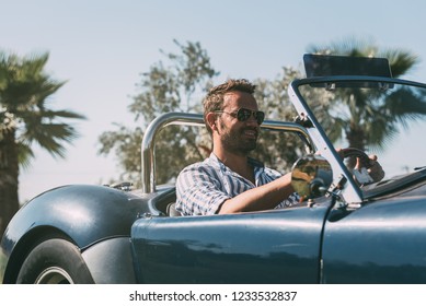 Man Driving A Convertible Vintage Car