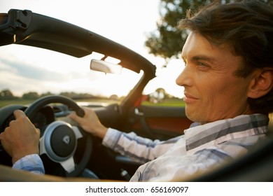 Man Driving An Electric Sports Car