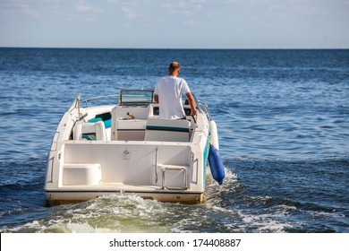 Man Driving A Fast Boat 