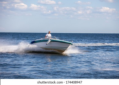 Man Driving A Fast Boat 