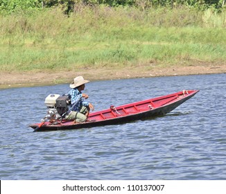 Man Driving Fishing Boat In Lake