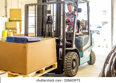 Man Driving Forklift Truck On A Warehouse 