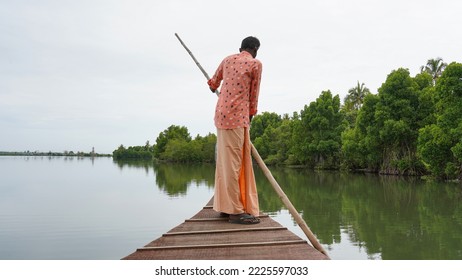 Man Driving His Boat In Backwater Lake.