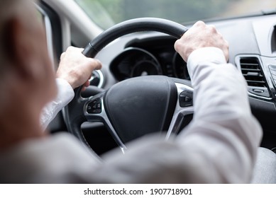 Man Driving With His Two Hands On Steering Wheel