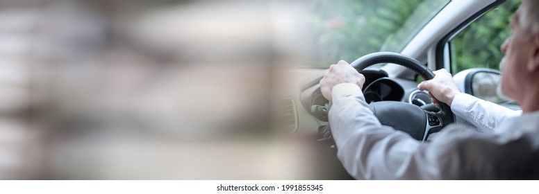 Man Driving With His Two Hands On Steering Wheel; Panoramic Banner