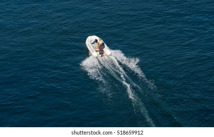 Man Driving An Inflatable Boat With A Motor