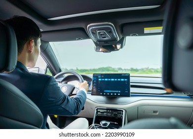 A Man Driving Inside Of Electric Car. Electric Car. EV Car. EV Vehicle.