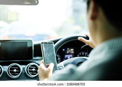 Man Driving and Left Hand Using Smartphone with Blank Screen - Shutterstock ID 1080488705