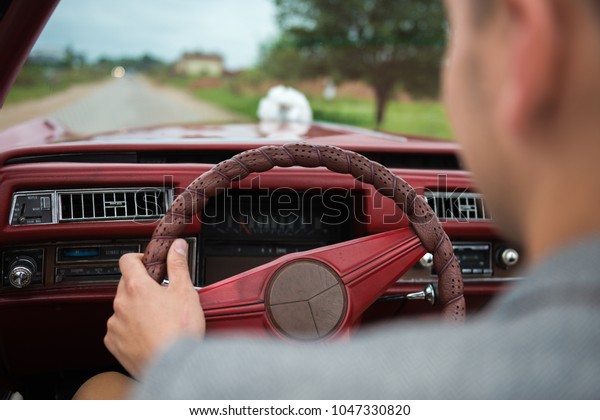 man driving old retro\
wedding car