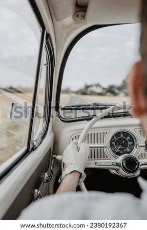 Man driving an oldtimer car with gloves