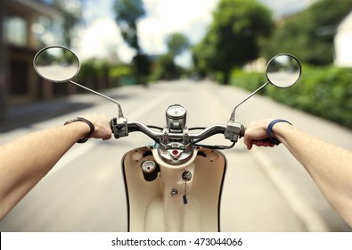 Man Driving On Scooter At Old Streets In City