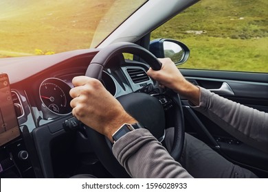 Man Driving Right Hand Car. Close-up Shot Of Man's Hands Holding Steering Wheel. Travelling, Renting A Car Abroad.