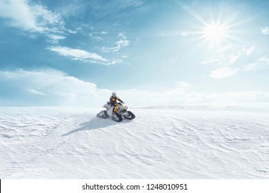 Man driving sports snowmobile in Finnish Lapland in a sunny day