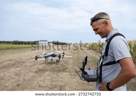 Man with Drone Controller in Field Prepare Flight for Agricultural Aerial Survey