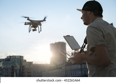 Man with drone flying at the city