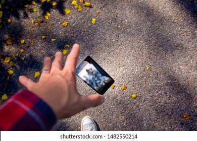 Man Dropping His Smartphone Ad Trying To Reach It. Phone Screen Is Cracked And Needs Repairing. Great Photo To Advertise Smartphone Repair Shop, Screen Repair Or Water Damage. 