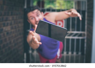 Man Dropping And Trying To Catch His Mobile Phone.