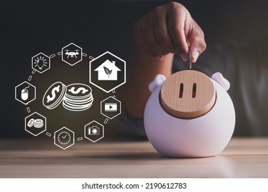 Man Drops Coins Into Cute Pig Piggy Bank, Enjoys Saving Coins At Home During Crisis Reduce Family Expenses Family Saving Money Concept Icon For Future Spending To Improve Quality Of Life