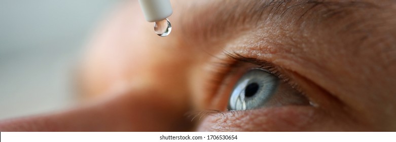 Man drops eye drops install lenses, moisturizing. Preservation and solution vision problems. Eye diseases are recognized. Drops before putting on lenses or before removing at end day